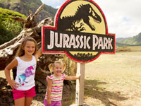 small children near the Jarassic Park sign at Kualoa Ranch in Oahu