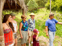 guide showing visitors to kualoa ranch the island plants
